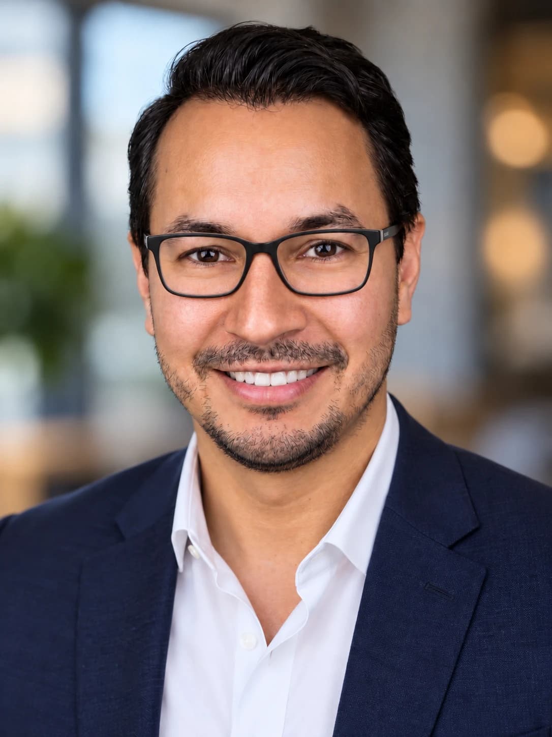Robert Lara III, smiling, in a navy blazer and white shirt